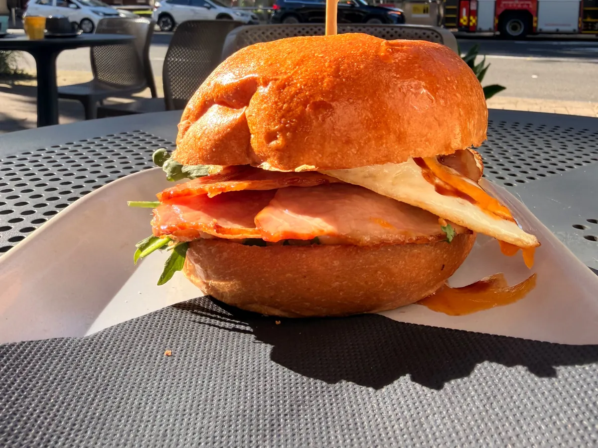 Bacon and egg roll on a table outside Silo West