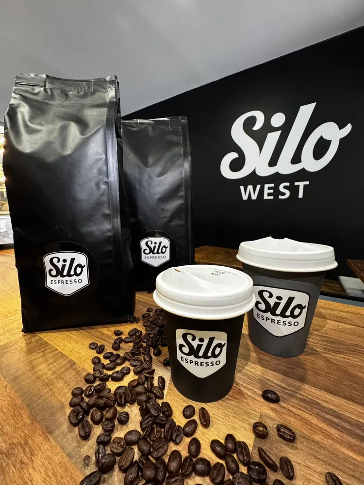 Two bags of Silo coffee beans with takeaway cups