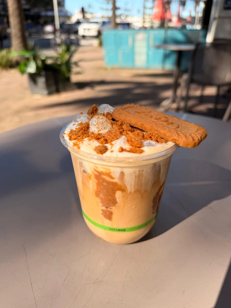 A Biscoff Latte topped with vanilla cold foam and a Biscoff biscuit