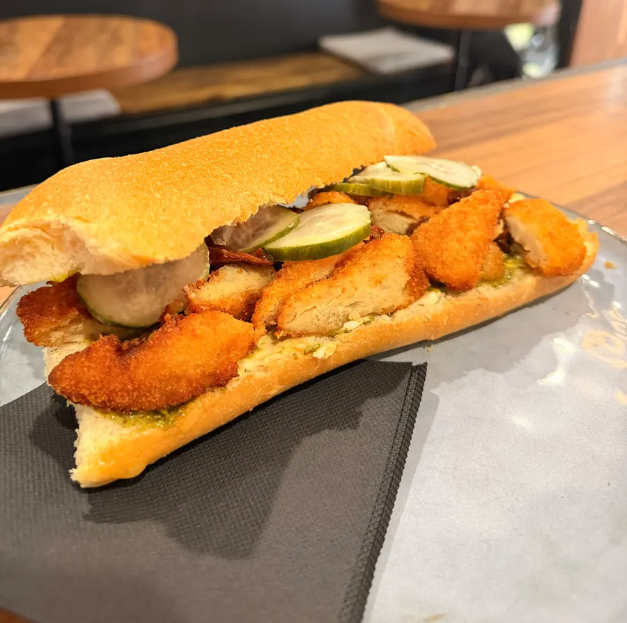 Crumbed chicken cotoletta panini with pickled cucumber