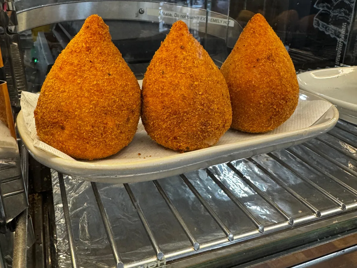 Three coxinhas in the food display