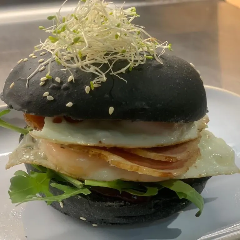 A burger on a charcoal bun