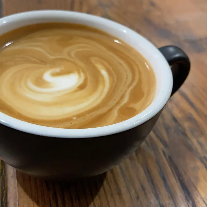A flat white at the table