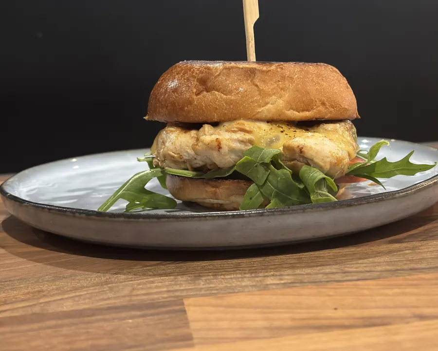 Grilled chicken burger with rocket on milk bun
