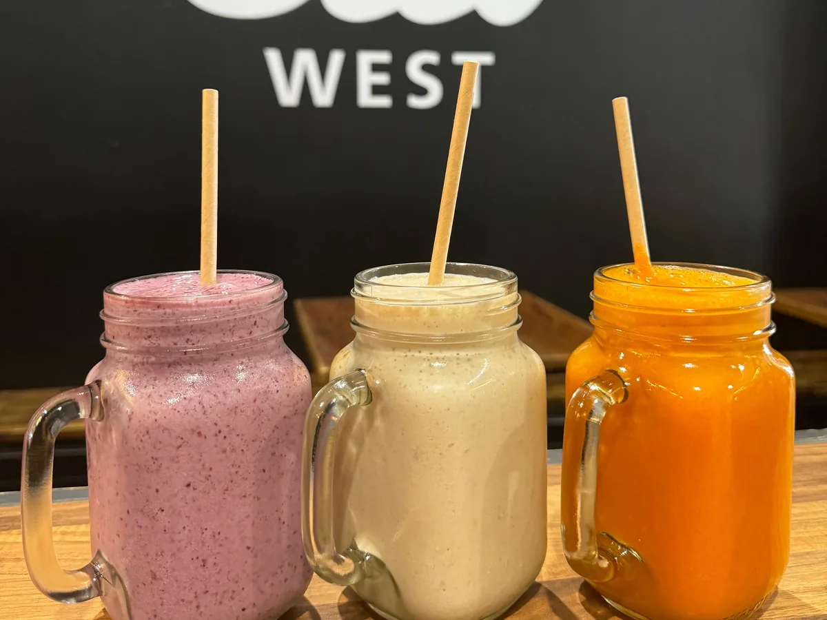 Three smoothies in jars in front of the Silo West sign